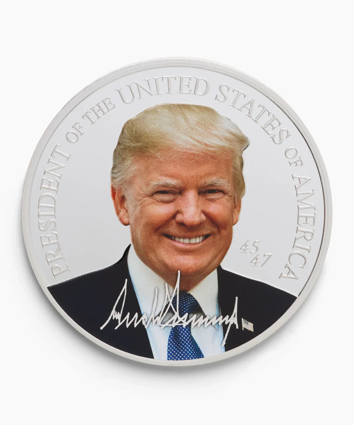 Silver Trump collectible coin with color portrait, 'President of the United States of America' and signature